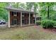 Traditional brick home with white columns, shutters, and a well-manicured lawn and tree-lined landscape at 3539 Evans Mill Rd, Lithonia, GA 30038
