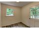 Bright hallway with clean white walls and vinyl floors, leading to a back door and a window view at 3539 Evans Mill Rd, Lithonia, GA 30038