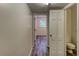 Hallway with updated vinyl floors and a view of a bathroom and back door for convenience at 3539 Evans Mill Rd, Lithonia, GA 30038