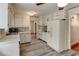 Kitchen with white cabinets and appliances, and updated flooring at 3539 Evans Mill Rd, Lithonia, GA 30038