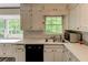 Eat-in kitchen with white cabinetry, undermount sink, and view of wooded yard at 3539 Evans Mill Rd, Lithonia, GA 30038
