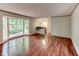 Open living room with a bay window, hardwood floors, and easy access to other areas of the house at 3539 Evans Mill Rd, Lithonia, GA 30038