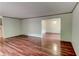 Spacious living room with hardwood flooring, neutral color scheme, and an open doorway to another room at 3539 Evans Mill Rd, Lithonia, GA 30038