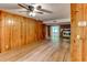 Living room featuring wood paneling, a fireplace with brick surround, and hardwood floors at 3539 Evans Mill Rd, Lithonia, GA 30038