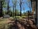 A serene backyard featuring a white shed, tall trees, and a rustic fence at 4103 Laynewood, Tucker, GA 30084