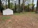 A large backyard provides ample space, complemented by a white storage shed and surrounding trees at 4103 Laynewood, Tucker, GA 30084