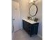 Bathroom featuring a modern navy vanity, black faucet, and white countertop at 4103 Laynewood, Tucker, GA 30084
