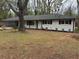 Charming single-story home with fresh exterior paint, mature trees, and a welcoming front yard at 4103 Laynewood, Tucker, GA 30084