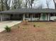 Charming single-story home with fresh exterior paint, manicured landscaping, and a covered carport at 4103 Laynewood, Tucker, GA 30084