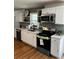 Updated kitchen featuring stainless steel appliances, subway tile backsplash, and bright white cabinetry at 4103 Laynewood, Tucker, GA 30084