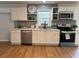 Bright kitchen featuring stainless appliances, quartz counters, open shelves and wood-look flooring at 4103 Laynewood, Tucker, GA 30084