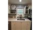 Close-up of the kitchen sink area with stainless steel sink, quartz countertop, and stylish backsplash at 4103 Laynewood, Tucker, GA 30084