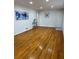 Well-lit living room with hardwood floors, modern artwork, and elegant decorative accents at 4103 Laynewood, Tucker, GA 30084