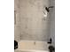 Shower stall with large marble style tiles and black shower head at 4103 Laynewood, Tucker, GA 30084