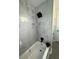 Shower stall with large marble style tiles and a black shower head and faucet at 4103 Laynewood, Tucker, GA 30084