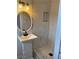 Bathroom featuring a shower with marble-style tiles and a sink with black fixtures at 4103 Laynewood, Tucker, GA 30084