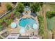 An aerial view of a private backyard featuring a pool with a spa, fire pit and lounge area at 4388 Cades Pointe, Marietta, GA 30066