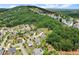 Aerial view of a wooded neighborhood, with many houses having swimming pools in the backyard at 4388 Cades Pointe, Marietta, GA 30066