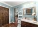 Bathroom features a stylish vanity with a decorative mirror and wood cabinets at 4388 Cades Pointe, Marietta, GA 30066