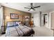 Bedroom features a wood accent wall, a ceiling fan and a cozy bed with a plaid comforter at 4388 Cades Pointe, Marietta, GA 30066