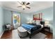 Bedroom featuring a ceiling fan, big windows with natural light, bench, and a bed at 4388 Cades Pointe, Marietta, GA 30066
