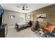 Bedroom includes a wood accent wall, a ceiling fan, and a comfortable bed with a leather chair at 4388 Cades Pointe, Marietta, GA 30066