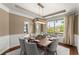 Elegant dining room featuring a modern light fixture, stylish table setting, and beautiful wainscoting details at 4388 Cades Pointe, Marietta, GA 30066