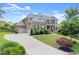 Beautiful two-story brick home with a large driveway and lush landscaping at 4388 Cades Pointe, Marietta, GA 30066
