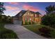 Charming two-story brick home featuring an attached two-car garage, manicured lawn, and beautiful landscaping at 4388 Cades Pointe, Marietta, GA 30066
