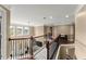 Sunlit upstairs hallway showcasing hardwood floors, decorative railing and open layout at 4388 Cades Pointe, Marietta, GA 30066
