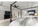 This main bedroom features a tray ceiling, four poster bed, and a view of the ensuite bathroom at 4388 Cades Pointe, Marietta, GA 30066