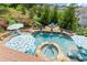 Inviting backyard featuring a sparkling pool, hot tub, and cozy seating area at 4388 Cades Pointe, Marietta, GA 30066