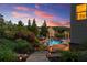 Backyard pool oasis with lush landscaping, a waterfall feature, and comfortable lounge seating, perfect for relaxation at 4388 Cades Pointe, Marietta, GA 30066