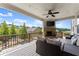 Covered porch with an outdoor fireplace, TV, and comfortable seating at 4388 Cades Pointe, Marietta, GA 30066