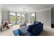 This sitting room is filled with natural light and features a comfortable blue sofa at 4388 Cades Pointe, Marietta, GA 30066