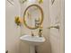 A half bathroom featuring a pedestal sink with decorative floral accents at 502 Fortune Ridge Rd, Stone Mountain, GA 30087