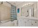 This bathroom features a single sink vanity, tiled bathtub, and a colorful shower curtain at 502 Fortune Ridge Rd, Stone Mountain, GA 30087