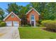 Charming brick two-story home with a well-manicured lawn and a two-car garage at 502 Fortune Ridge Rd, Stone Mountain, GA 30087