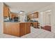 Spacious kitchen with wood cabinets, tile floors, and a granite-topped breakfast bar at 502 Fortune Ridge Rd, Stone Mountain, GA 30087
