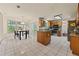 An open kitchen with an island, stainless steel appliances and an adjacent breakfast nook at 502 Fortune Ridge Rd, Stone Mountain, GA 30087