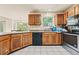 Functional kitchen with stainless steel appliances, wooden cabinets, and ample counter space at 502 Fortune Ridge Rd, Stone Mountain, GA 30087