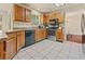 Well-equipped kitchen with stainless steel appliances, tile floor and wood cabinets at 502 Fortune Ridge Rd, Stone Mountain, GA 30087
