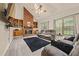 A well-lit living room boasts a brick fireplace and hardwood flooring at 502 Fortune Ridge Rd, Stone Mountain, GA 30087