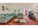 Comfortable living room with hardwood floors, plush sofas, and a view to the foyer at 502 Fortune Ridge Rd, Stone Mountain, GA 30087
