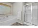 Bright bathroom featuring a separate tub and glass-enclosed shower with tile flooring at 47 Gloster Mill Way, Lawrenceville, GA 30044