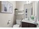 A modern bathroom featuring a toilet, vanity, and decor at 47 Gloster Mill Way, Lawrenceville, GA 30044