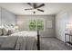 Bedroom with a ceiling fan, wallpapered wall, window, and a bedside table at 47 Gloster Mill Way, Lawrenceville, GA 30044