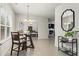 Bright dining area featuring a chandelier, modern table set, and a beverage cart at 47 Gloster Mill Way, Lawrenceville, GA 30044
