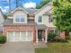 Charming two-story home featuring a brick facade and a well-manicured front yard at 47 Gloster Mill Way, Lawrenceville, GA 30044