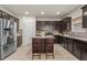 Well-equipped kitchen with stainless steel appliances, dark cabinetry, and a center island with seating at 47 Gloster Mill Way, Lawrenceville, GA 30044